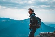 Man Wearing Jacket Carrying A Backpack